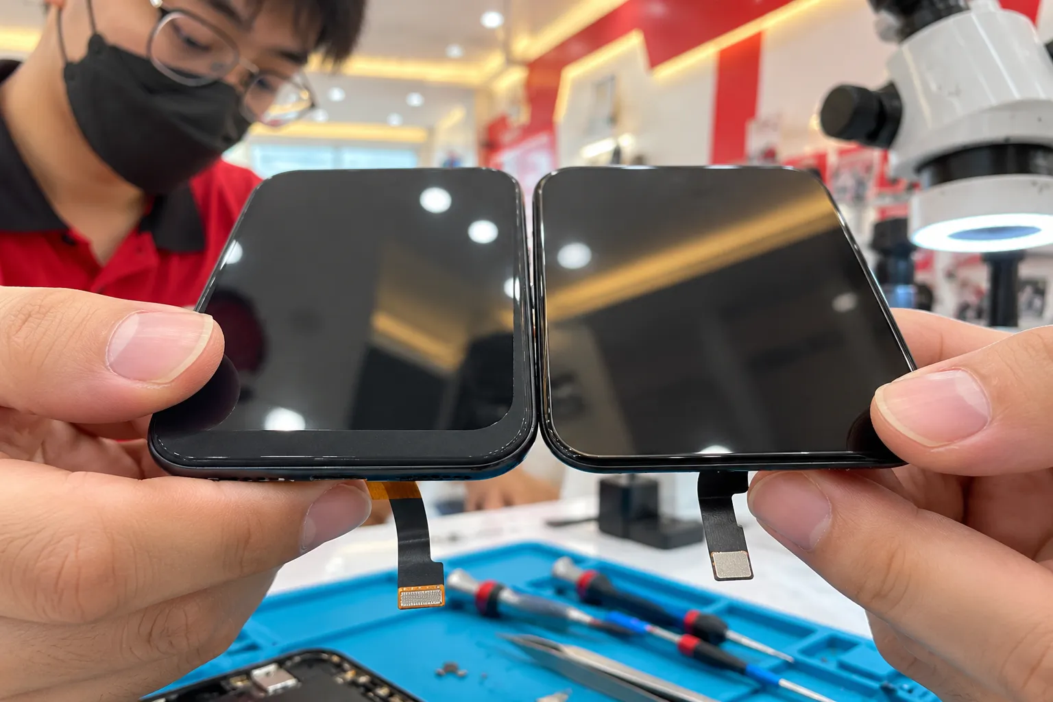 Close-up comparing the black border of an original screen and a TFT screen